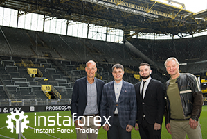 ตำนาน Borussia Dortmund Wolfgang de Beer, ผู้อำนวยการด้วยพัฒนาธุรกิจจาก InstaForex คุณ Pavel Shkapenko, ผู้อำนวยการด้วยพัฒนาธุรกิจจาก InstaForex ในเอเชียคุณ  Roman Tcepelev และซีอีโอของ Borusssia Carsten Cramer ด้านหน้าของสนามกีฬาแบบยืนชมอันยิ่งใหญ่ที่สุดในยุโรปที่อยู่ในพื้นที่เขตภายใต้ของสนามกีฬา SingalIduna Park Stadium